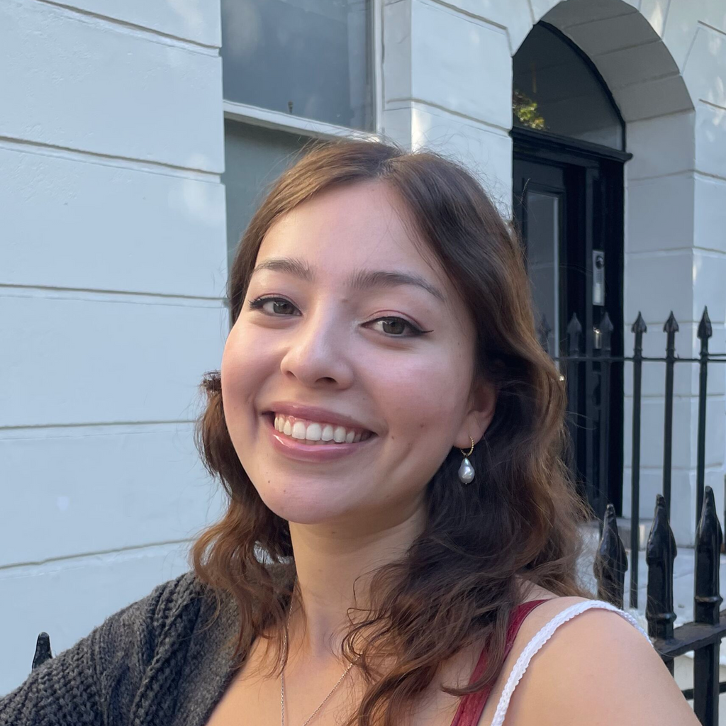 a silig dark haired woman wearing baroque pearl earrings by Misia Mae