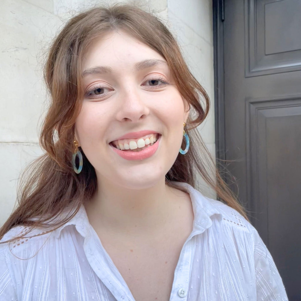 A light brown hair woman wearing blue earrings from the Audrey collection by Misia Mae