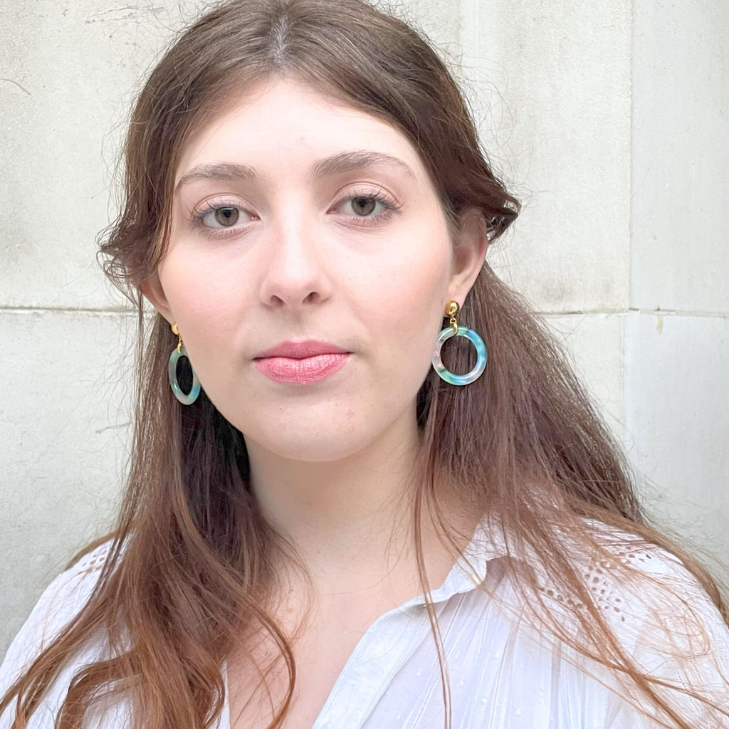 A light brown hair woman wearing blue earrings from the Audrey collection by Misia Mae