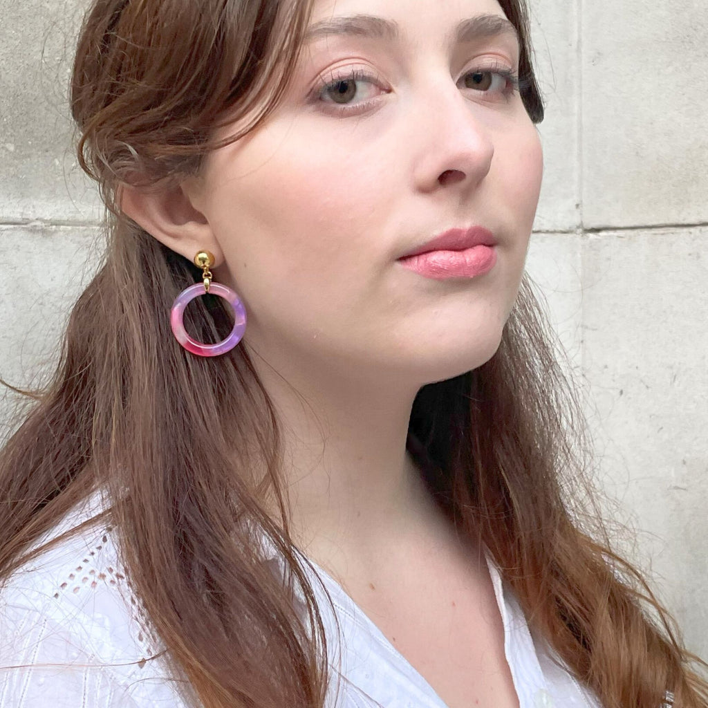 a light brown hair woman wearing purple tortoiseshell earrings from the Audrey collection by Misia Mae