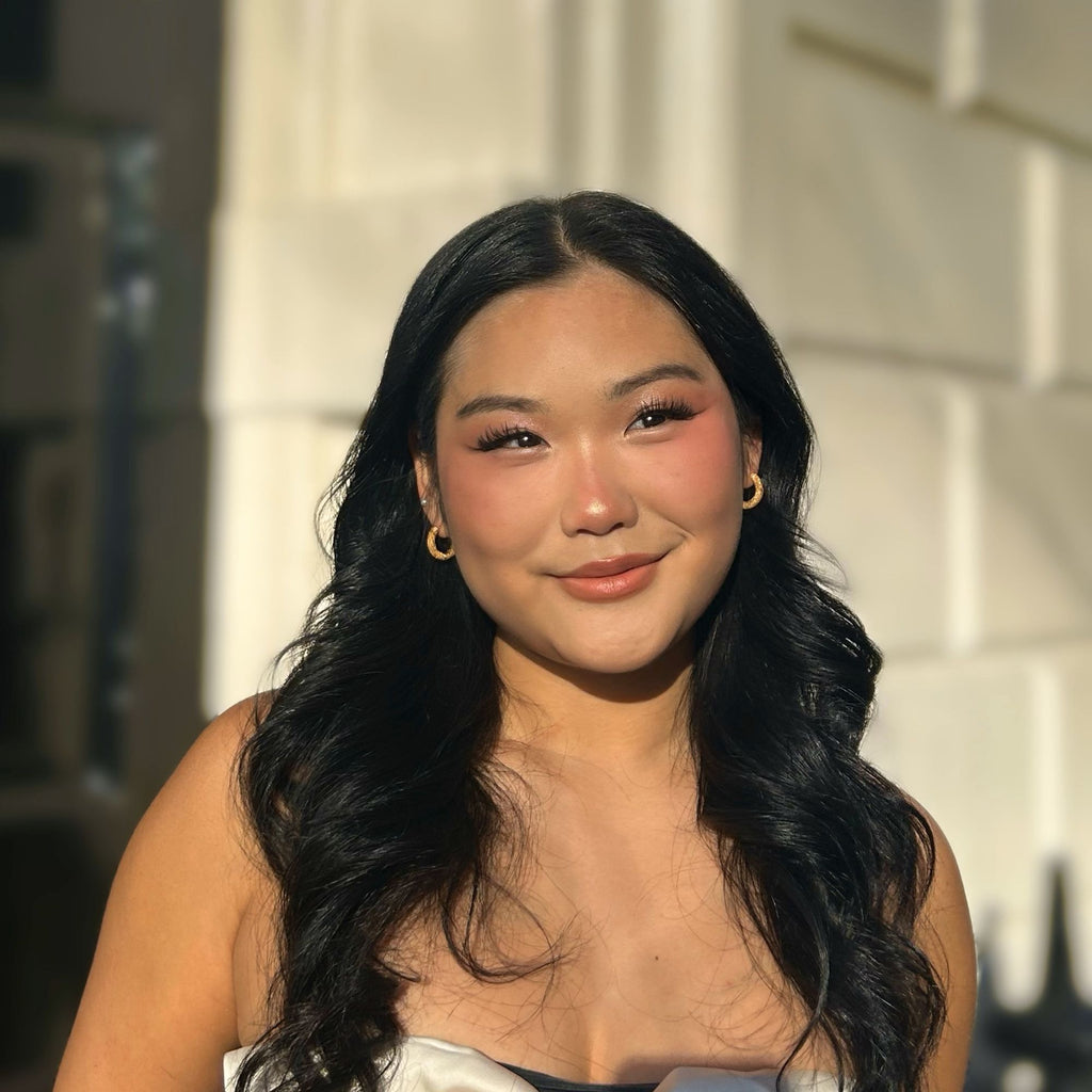 A brunette woman wearing chunky earrings gold