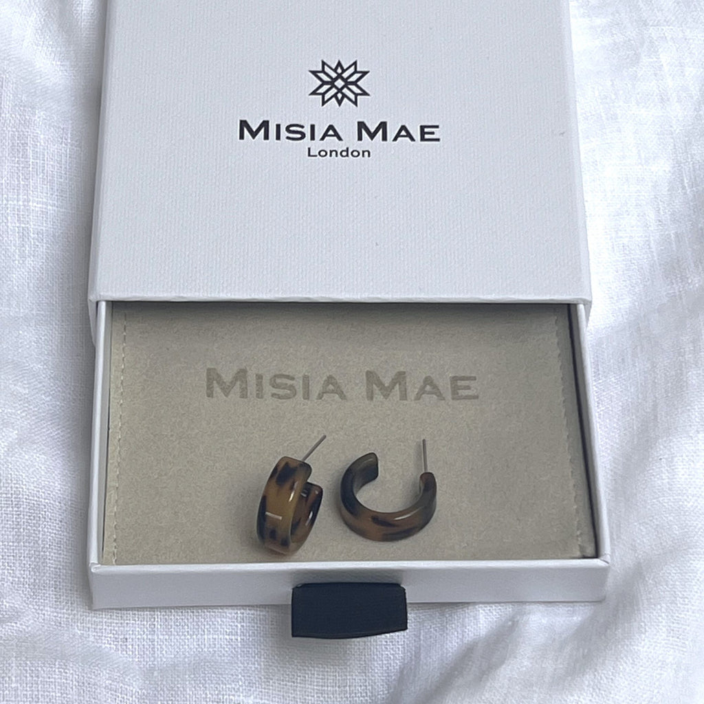 Tortoiseshell earrings brunette in a Misia Mae jewellery box on a white linen fabric. Earrings by Misia Mae